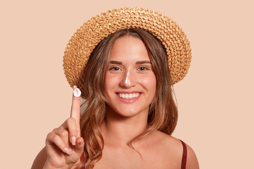 Woman wearing a hat and sunscreen