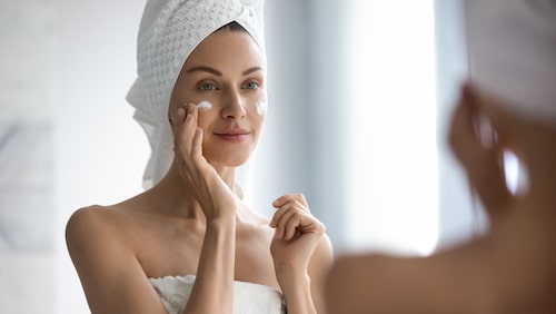 Woman with dry or dehydrated skin applying facial cream